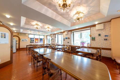 a row of tables and chairs in a restaurant at Lodge Matsuya in Nozawa Onsen