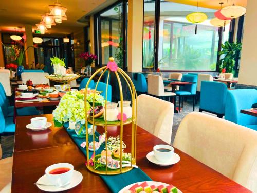a table with a buffet of food in a restaurant at Happy Life Memories Hoi An Hotel & Spa in Hoi An