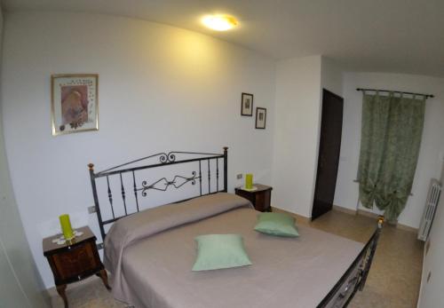 Un dormitorio con una cama con dos almohadas verdes. en La Magnolia, en Verona