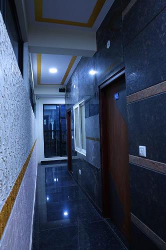 a hallway of a building with a door and a window at Hotel jetway in Muthugadahalli