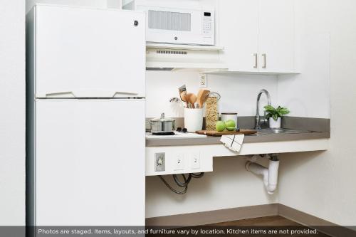 a kitchen with a sink and a white refrigerator at InTown Suites Extended Stay Charleston SC - West Ashley in Charleston