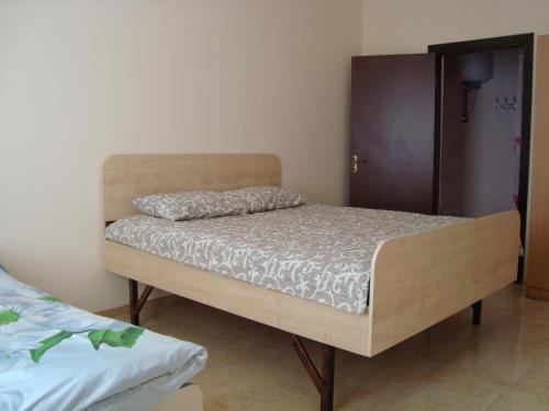 a bed in a room with a wooden bed frame at Hostel Sofia in Zhytomyr