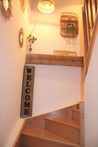 a room with a staircase with a sign on the wall at O'BERCAIL in Tournon-sur-Rhône