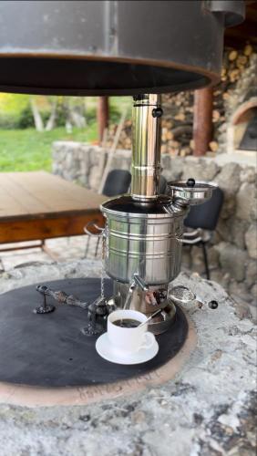 a coffee maker with a cup of coffee on a table at Toneh Villa in Lernarot
