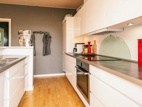 a kitchen with white cabinets and a counter top at Exclusive Retreat with Spa - By Traum Ferienwohnungen in Rømø Kirkeby