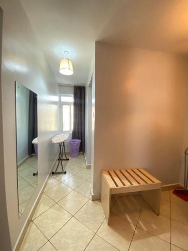 a room with a bench and a table at ENZI FURNISHED APARTMENT DIANI in Ukunda