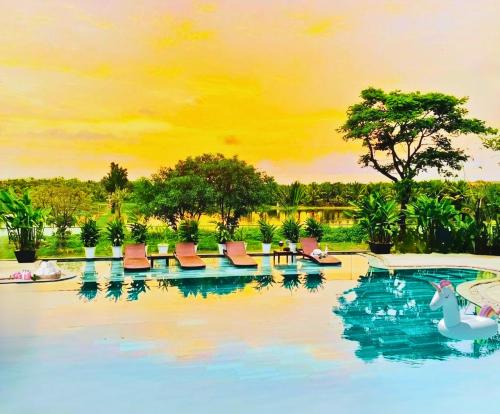 a painting of a swimming pool with a swan and chairs at Happy Life Memories Hoi An Hotel & Spa in Hoi An