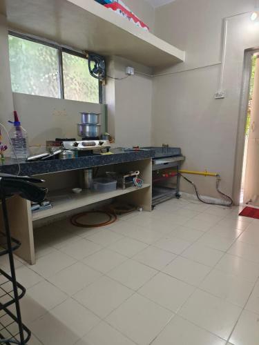 a kitchen with a counter top in a room at Vyavasthapan hostels in Pune