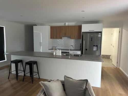 a kitchen with a sink and a counter top at Newly Renovated Coastal Retreat in Port Kenny