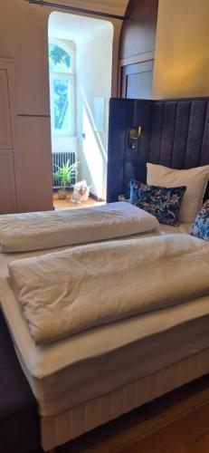 a bedroom with two beds and a stair case at Schlosshotel Hohenbocka in Hohenbocka
