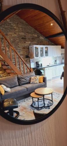 a living room with a couch and a table at Le Chalet - Maison de vacances in La Roche-en-Ardenne