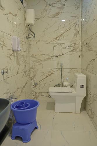 a bathroom with a toilet and a sink at VITS Select Diamond Resort Sasan Gir in Talala