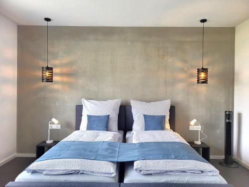 a bedroom with two beds with blue and white pillows at Ferienhaus Schlossterrassen 8b in Pouch
