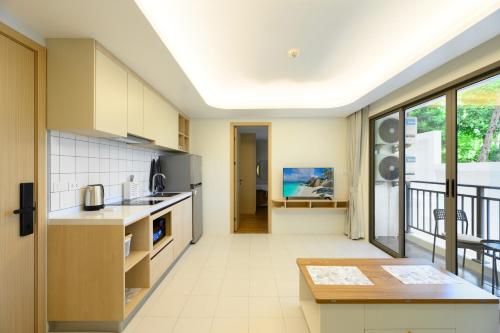 an open kitchen with a view of a balcony at Fantasea Condo Kamala B211 2BDRM by Phuket Sabay Rent in Kamala Beach