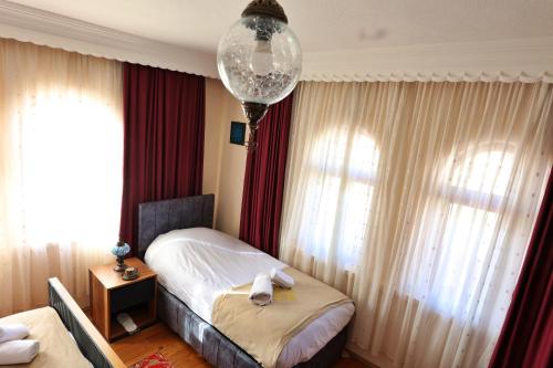 a hotel room with a bed and a chandelier at Cappadocia Hostel in Goreme
