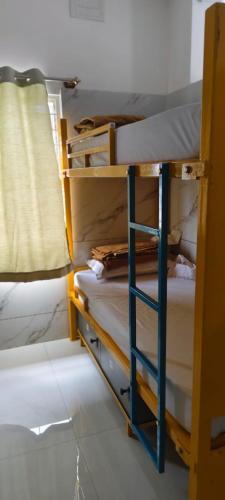 a room with two bunk beds in a room at V R S Luxury AC Male Dormitory in Mysore