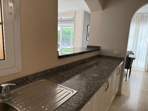 a kitchen counter with a sink and a mirror at La Caleta Luxury Seaside Villa with 3 Bedrooms and Private Pool in Adeje