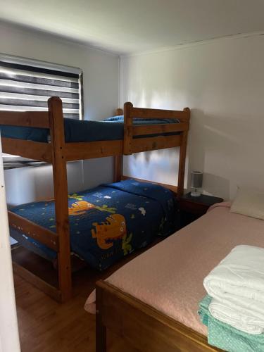 a bedroom with two bunk beds and a bed at Cabaña Floppy Yumbel opción Tinaja in Yumbel