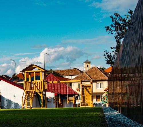 a playground in front of a building with a fence at FLH - Citadel Garden Central Free Parking in Alba Iulia