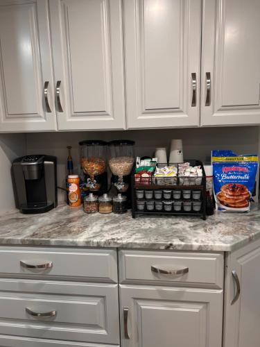 a kitchen counter with white cabinets and food on it at The Highland Oasis in Ephrata
