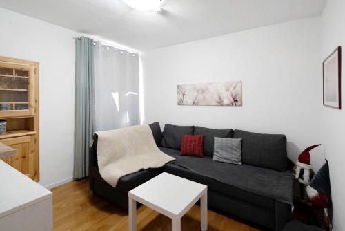 a living room with a couch and a table at Ciasa de Lucky in Moena