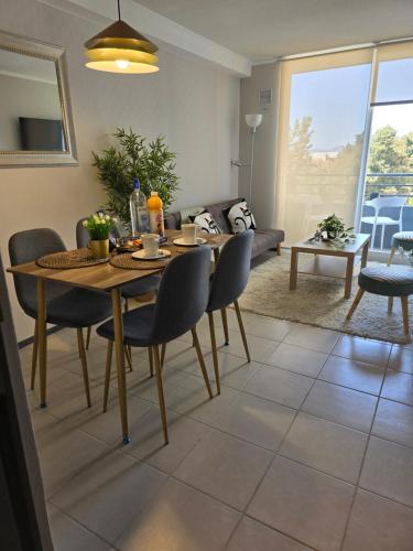 a living room with a wooden table and chairs at Nuevo departamento gran ubicacion central in Rancagua
