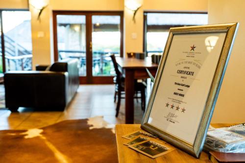 a sign sitting on a table in a restaurant at 7th Hole Golf Lodge in Modimolle