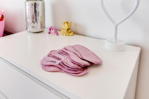 a white table with a pink blanket and a mirror at Seafront apartment in Bognor Regis