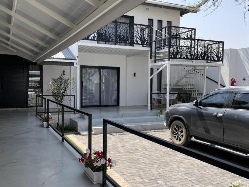 a car parked in front of a house at The Amaryllis Guest House in Mariental