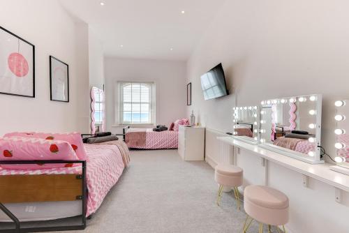 a girls bedroom with two beds and a desk at Seafront apartment in Bognor Regis