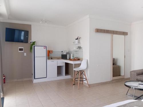 a kitchen with a refrigerator and a table in it at The Amaryllis Guest House in Mariental