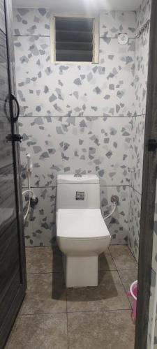 a bathroom with a toilet in a room at V R S Luxury AC Male Dormitory in Mysore