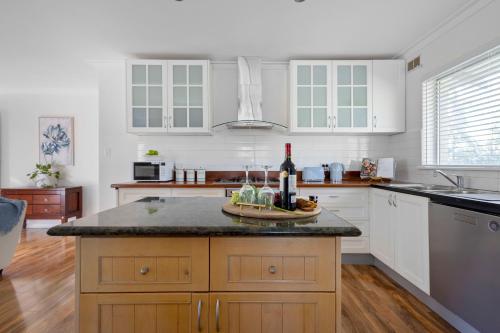 a kitchen with a counter with a bottle of wine at 10/17 Richardson Street, South Perth in Perth