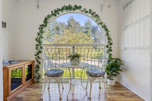 an arched window with a table and two chairs at 10/17 Richardson Street, South Perth in Perth