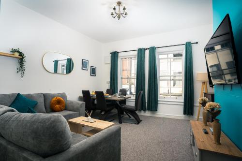 a living room with a couch and a table at Central Yeovil Stay Contractors Free Wi-Fi in Yeovil