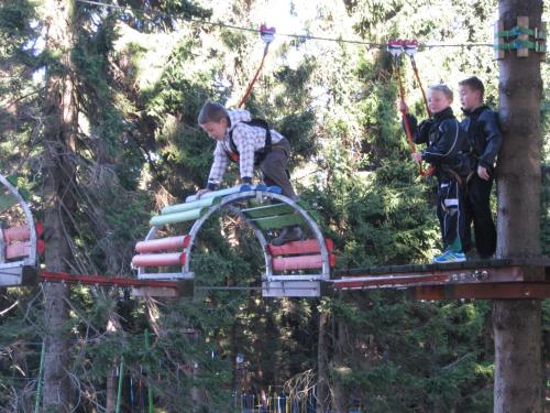 three children on a zip line at a amusement park at Holiday Home Abertamy near Ski Slopes in Abertamy