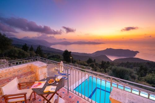 a pool on a balcony with a view of the ocean at Kamini by Vintage Travel in Dhefaranáta