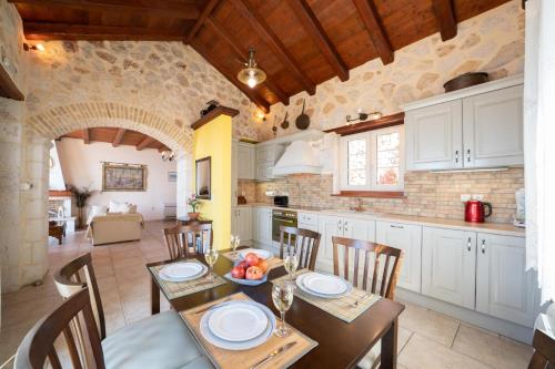 a kitchen and dining room with a table and chairs at Kamini by Vintage Travel in Dhefaranáta