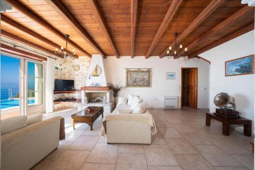 a living room with a couch and a fireplace at Kamini by Vintage Travel in Dhefaranáta