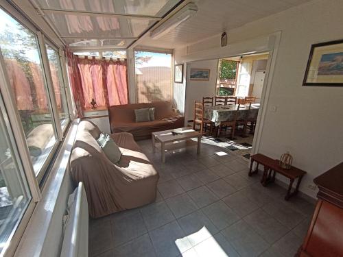 a living room with a couch and a table at Villa Bel Air in Saint-Étienne-les-Orgues