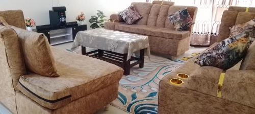 a living room with a couch and a table at SEBULENI SEA LUXURY HOMESTAY WALK TO NYALI BEACH Mombasa in Mombasa