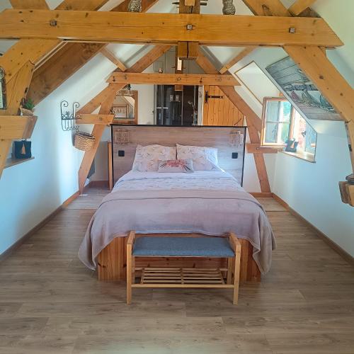 a bedroom with a large bed in a attic at Chez Eric et Nath in Bois-Herpin