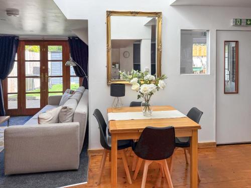 a living room with a table and a couch at The Spinney in Carterton