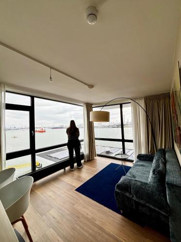 a woman sitting in a room with a large window at Delta Hotel in Vlaardingen
