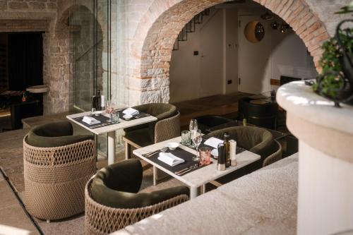 a dining room with two tables and chairs at Spirito Santo Palazzo Storico - Adults Only in Rovinj