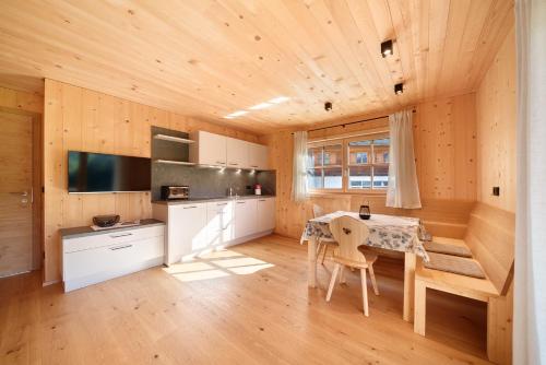 a kitchen with a table and chairs in a room at Gögelehof in Stulles