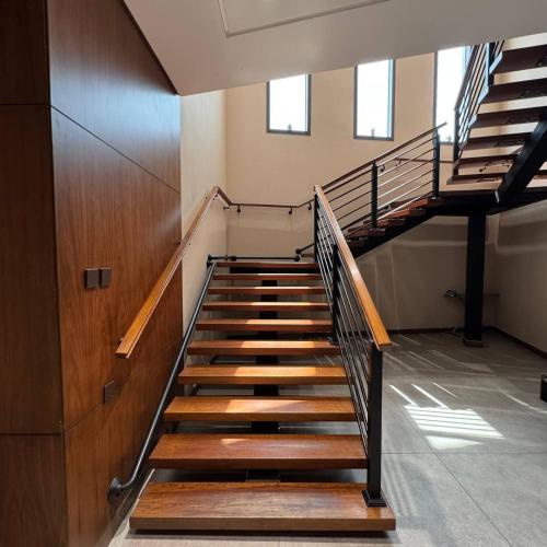 an empty staircase in a building with wooden steps at Midan Hotel & Suites Al Aziziya in Makkah