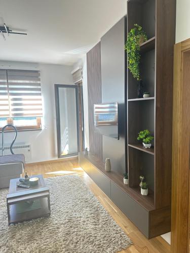 a living room with a couch and a table at Prestige apartmani Zlatibor-Prestige Forest Resort in Zlatibor
