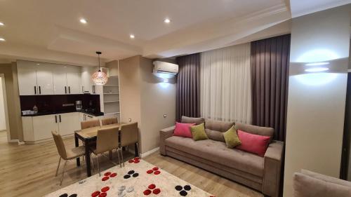 a living room with a couch and a table at Relaxing 2 beds Apartment, Quiet & Comfortable in Chişinău