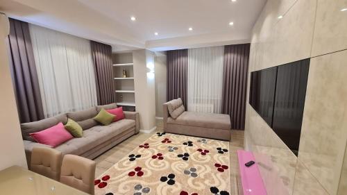 a living room with a couch and a rug at Relaxing 2 beds Apartment, Quiet & Comfortable in Chişinău